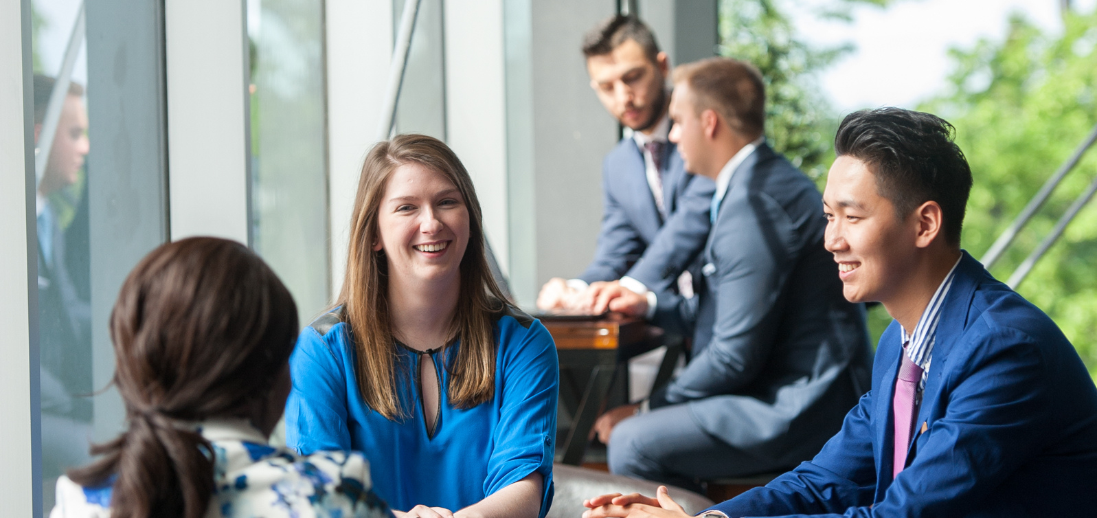 Students sit at a table talking