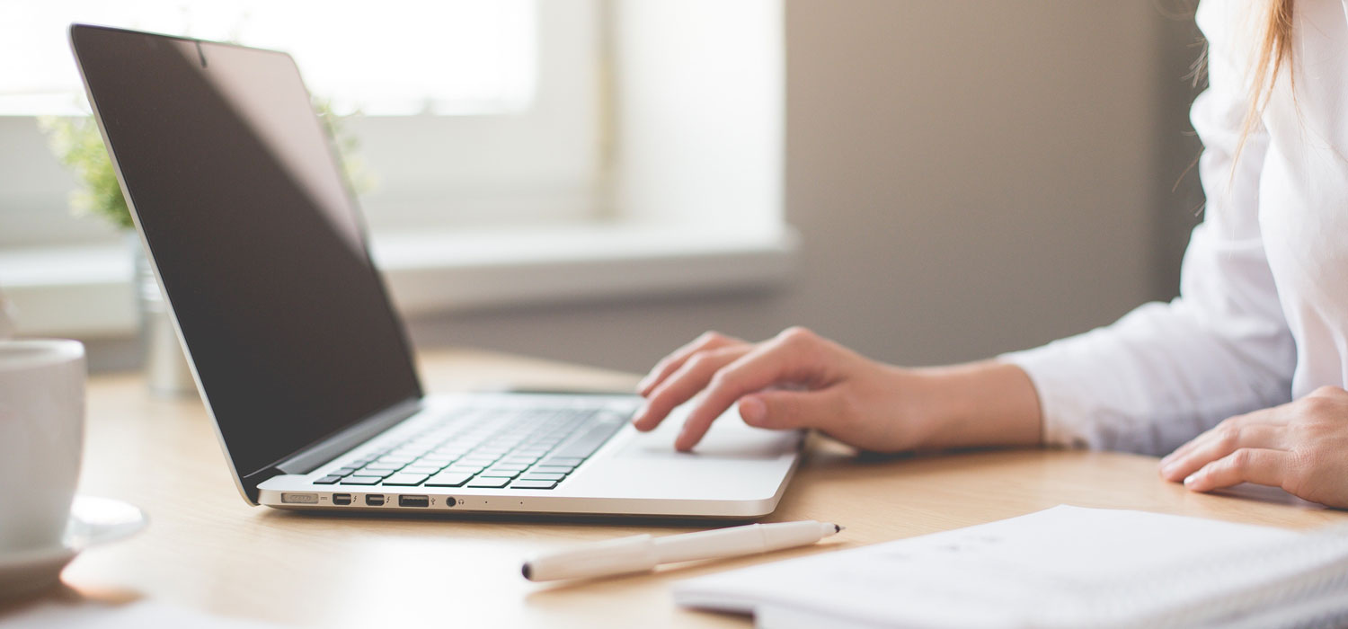 Person's hand using a laptop