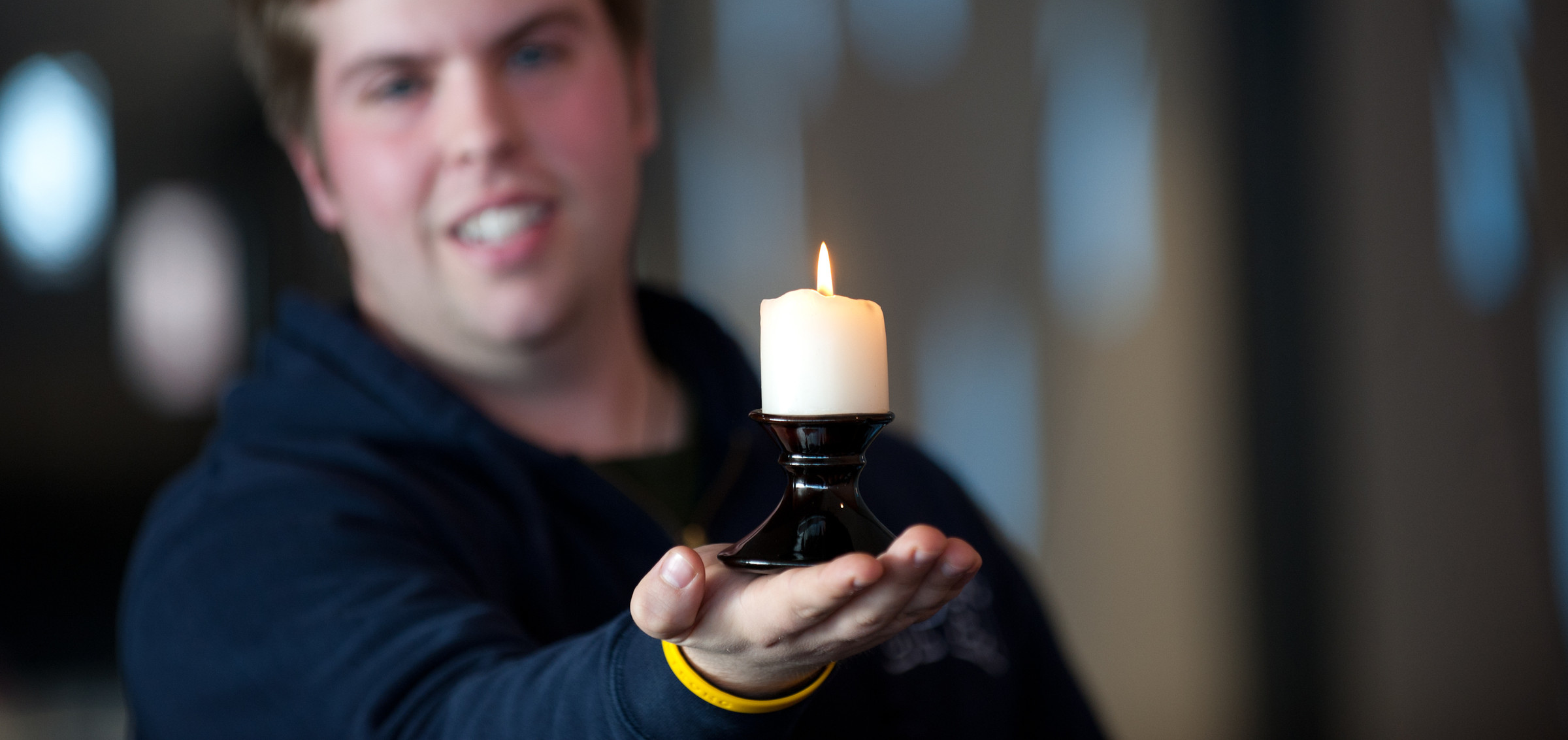 A student holds a candle