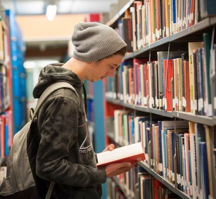 a student reads a book in the library