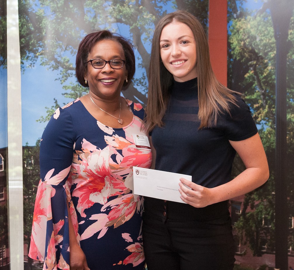 professor presenting a cheque to a student