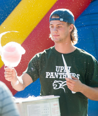 A man spins cotton candy at the campus carnival