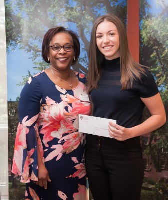 professor presenting a cheque to a student