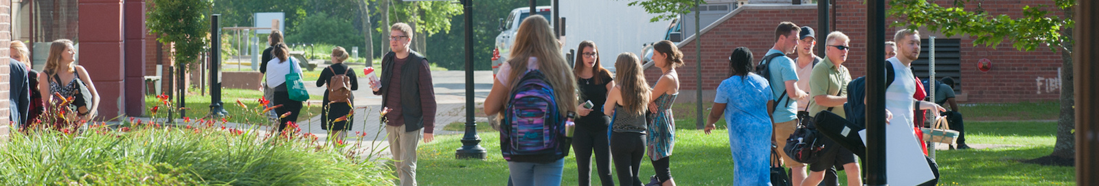 students in the quad in front of steel building 