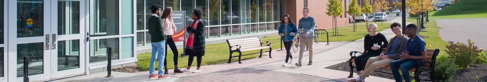 student in front of the faculty of sustainable design engineering building