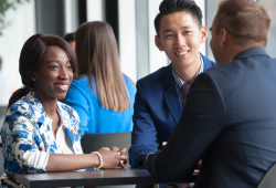 Students sit at a table talking