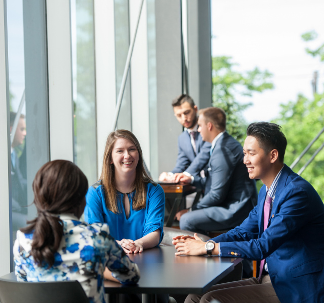 Students sit at a table talking